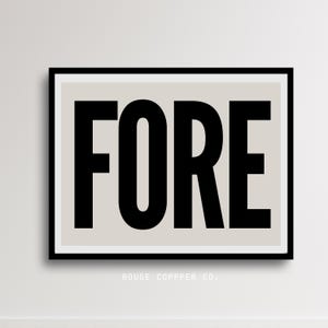 May include: A framed art print with the word "FORE" in bold, black letters centered on a light beige background. The print is in a black frame with a white border. The text "ROUGE COPPER CO." is printed in small, black letters at the bottom.