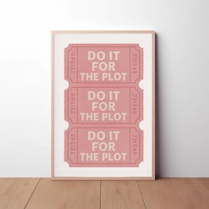 May include: A framed print featuring three pink ticket stubs with the text "DO IT FOR THE PLOT" in a bold font. Each ticket stub has the number "731549" printed on it. The print is in a light wood frame.