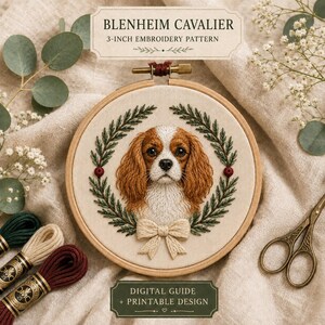 May include: A circular wooden embroidery hoop containing a stitched portrait of a Blenheim Cavalier dog framed by a green leaf wreath with a cream-colored bow. The text reads BLENHEIM CAVALIER 3-INCH EMBROIDERY PATTERN and DIGITAL GUIDE + PRINTABLE DESIGN.