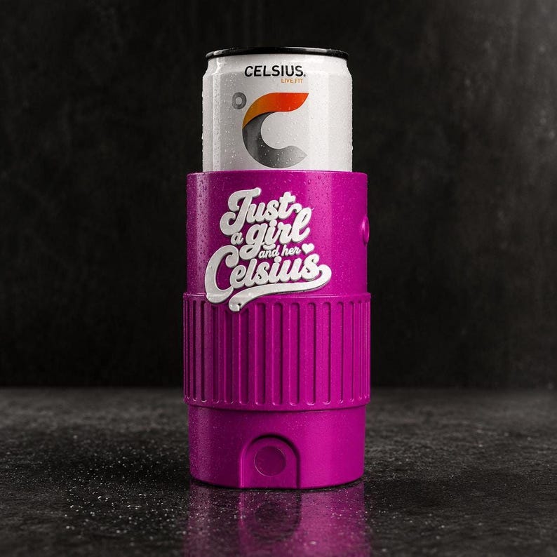 A can of CELSIUS drink is placed inside a purple cylindrical container with a textured surface, against a dark background.