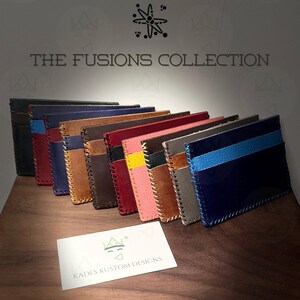May include: A collection of handcrafted leather wallets in various colors, including black, red, blue, and brown. Each wallet features unique stitching and a contrasting color scheme. The text "THE FUSIONS COLLECTION" is displayed above the wallets.