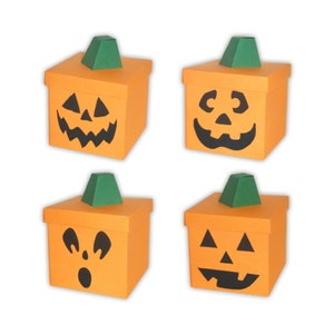 May include: Four orange pumpkin-shaped boxes with different jack-o'-lantern faces. Each box has a green stem on top.