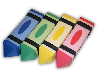 May include: Four colorful crayon-shaped boxes with black trim and a white oval in the center of each box. The boxes are arranged in a row from left to right, with the blue box on the left, followed by the green, yellow, and red boxes.