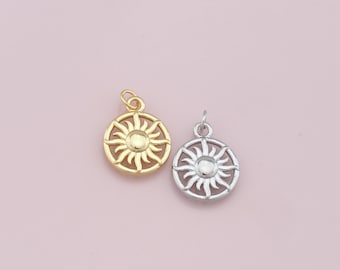 May include: Two sun charm pendants, one gold and one silver, with a detailed sun design.