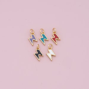 May include: Five gold-colored lightning bolt charms with different colored enamel fills: purple, teal, red, black, and white.