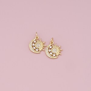 May include: Two gold-tone sun and moon charms with clear crystal accents. The charms are perfect for adding a touch of celestial style to jewelry projects.