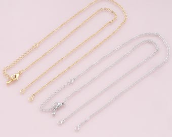 May include: Two chain necklaces, one gold and one silver, with lobster claw clasps and extension chains.