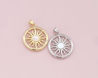 May include: Two sun pendant charms, one gold and one silver, with a white mother-of-pearl center. Both pendants feature a sun design with rays emanating from the center.