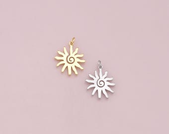 May include: Two sun charm pendants, one gold and one silver, with a spiral design in the center.