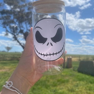 May include: A clear glass jar with a wooden lid and a black and white Jack Skellington face decal.