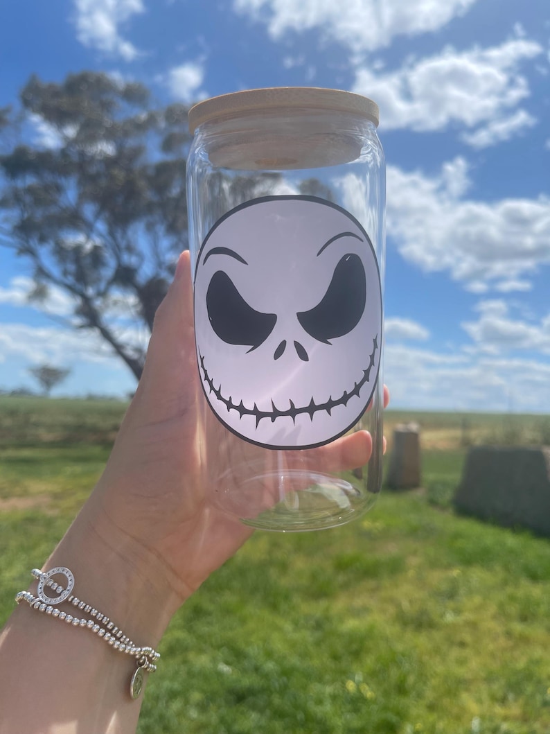 May include: A clear glass jar with a wooden lid and a black and white Jack Skellington face decal.