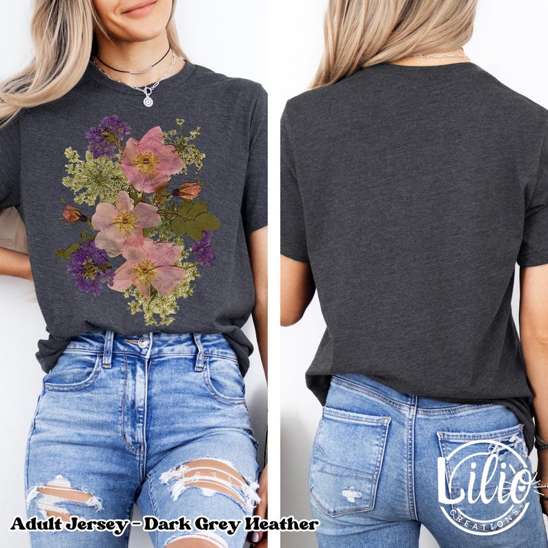 May include: Dark grey heather adult jersey t-shirt featuring a floral design in pink, purple, and green. The shirt has short sleeves and a crew neck. The text "Adult Jersey-Dark Grey Heather" is printed at the bottom of the image.