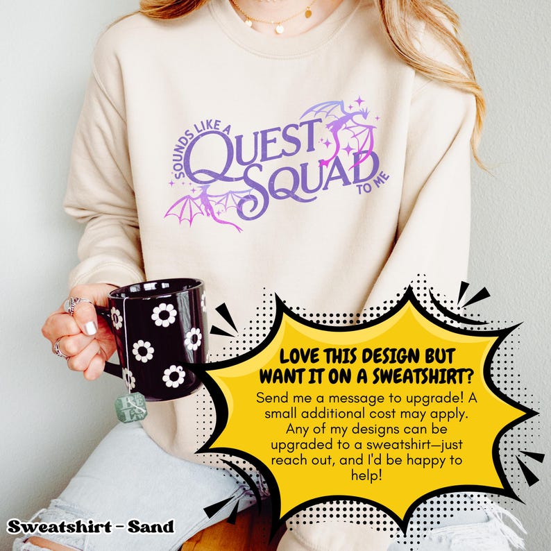 以下が含まれることがあります： サンドカラーのスウェットシャツに、紫とピンクのデザインで「Sounds like a Quest Squad to me」とドラゴン柄が描かれています。 「LOVE THIS DESIGN BUT WANT IT ON A SWEATSHIRT?」というテキストが黄色の吹き出しに入っています。