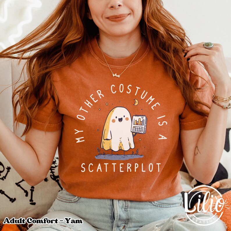 Pode incluir: Camiseta laranja com o texto "MY OTHER COSTUME IS A SCATTERPLOT". O gr&aacute;fico apresenta um fantasma de desenho animado segurando um gr&aacute;fico. A camisa &eacute; um tamanho adulto confort&aacute;vel.
