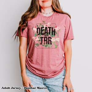 May include: A heather mauve adult jersey t-shirt with a floral design and the text "Death by TBR" printed on the front.