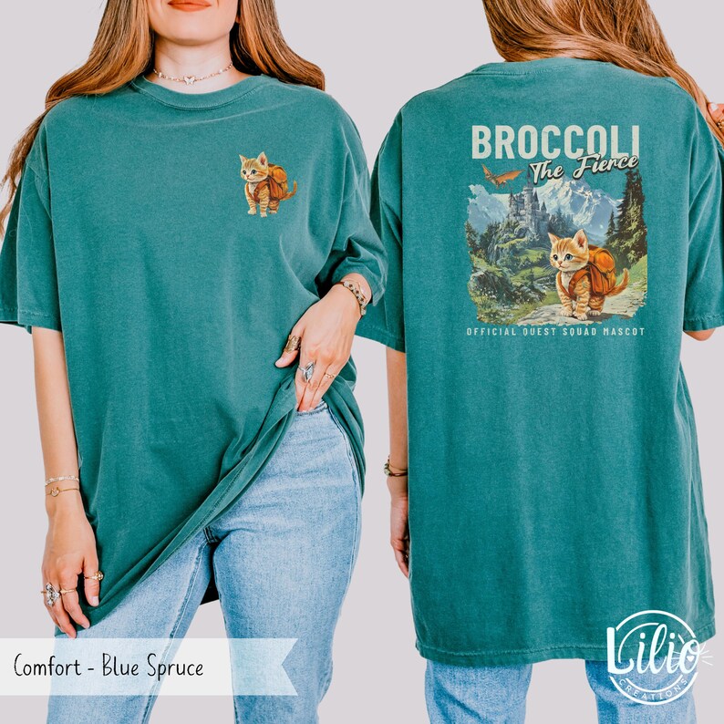 May include: A teal blue t-shirt with a graphic of a cat wearing a backpack and the text "Broccoli The Fierce" with the words "Official Quest Squad Mascot" below.
