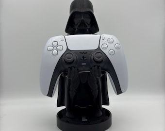 May include: A black Darth Vader figurine holding a white PlayStation 5 controller. The figurine is standing on a black base.
