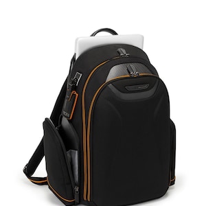 May include: Black backpack with orange trim and accents, holding a laptop. The backpack has multiple compartments and a top handle. The design includes a front pocket and a side pocket. The backpack is made of a durable material.