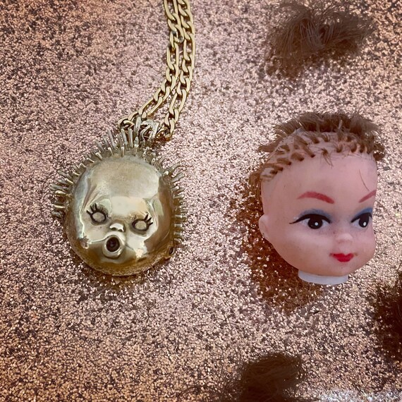 Baby head best sale necklace