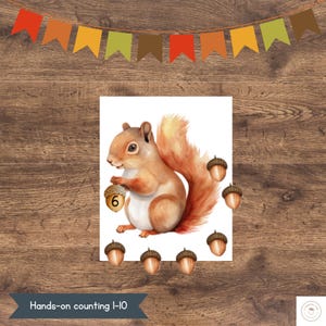 May include: A watercolor illustration of a squirrel holding an acorn with the number 6 on it, surrounded by acorns. The image is on a white background with the text "Hands-on counting 1-10" at the bottom. A banner of fall colors is at the top.