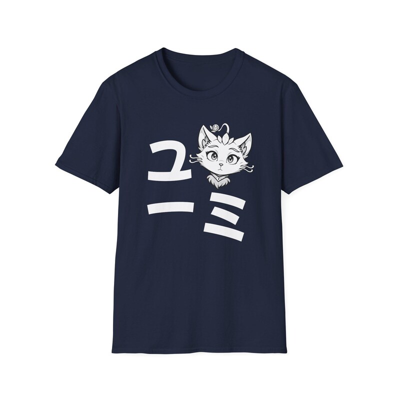 May include: Navy blue t-shirt featuring a white illustration of a cat's face with Japanese characters. The cat has large eyes and a decorative headpiece. The Japanese characters are vertically aligned to the left of the cat's face.