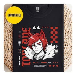 May include: Black t-shirt featuring a stylized anime character with red hair and a white fur collar. The design includes Japanese text, the word "TONE" in large red letters, and the name "SETT". A yellow "GUARANTEE" sticker is in the upper left.