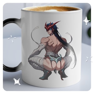 May include: White ceramic mug with a black handle. The mug features a colorful illustration of a person wearing a red mask and white bandages. The person is sitting with their legs crossed and their back to the viewer.