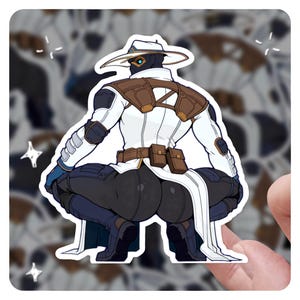 May include: A sticker depicting a character in a white and brown outfit, in a crouching position. The character wears a hat and has a futuristic design. The sticker has a white border and is held by a hand.