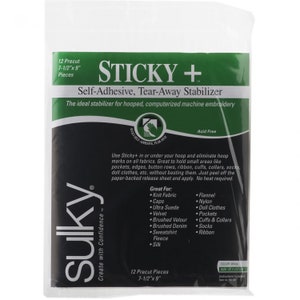 May include: A package of Sulky Sticky+ Self-Adhesive, Tear-Away Stabilizer for embroidery. The package is white with green and black text. It says "The ideal stabilizer for hooped, computerized machine embroidery." and lists 12 precut pieces that are 7-1/2 inches by 9 inches.