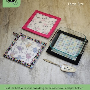 May include: A set of two pink and black silicone trivets and a pot holder with a colorful polka dot design. The trivets and pot holder are 9 1/2 inches square and feature a silicone overlay. The text "Hot Stuff Trivet & Pot Holder" and "Large Size" is visible in the image.