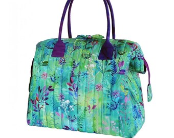 May include: A quilted handbag with a floral print in shades of green, blue, and purple. The bag has two purple handles and a zipper closure.