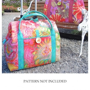 May include: Two colorful duffel bags with a floral pattern, one with a retractable handle. The bags are sitting on a wooden bench in a park setting. The text on the image reads "Bag Stays Size A for use with the Weekend Duffle (AT645) Use for either the TALL or SHORT Duffle".