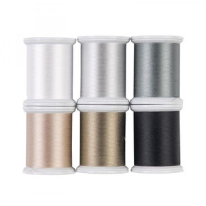 May include: Six spools of thread in various metallic colors, including silver, gray, gold, and black. The spools are arranged in two rows of three.
