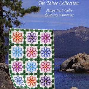 May include: A quilt with a white background and a pattern of colorful flowers in green frames. The quilt is titled "Flip & Fuse" Fun! The Tahoe Collection Happy Stash Quilts by Marcia Harmening."