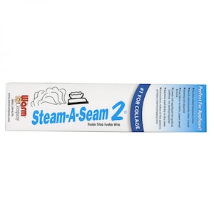 May include: A white box with blue and red text that reads "Steam-A-Seam 2" Double Stick Fusible Web. The box also has a picture of an iron and steam coming from it. The text "#1 For Collage" is on the right side of the box.