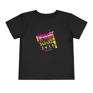 May include: Black t-shirt with a graphic print of a yellow and pink graffiti design that says "You down with ARC?" with a yellow and black brick background. The graphic also includes four icons representing "Track", "Play", "Record", and "Live". The text "The AP Life" is printed below the graphic.