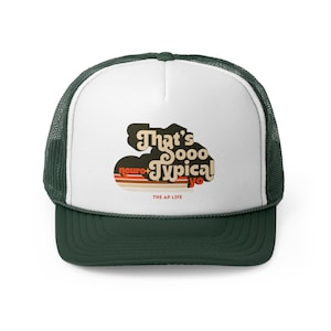 May include: A white and green trucker hat with a retro-style graphic that says "That's Sooo Typical" with the words "neuro" and "yo" in smaller font. The hat has a green mesh back and a white front.