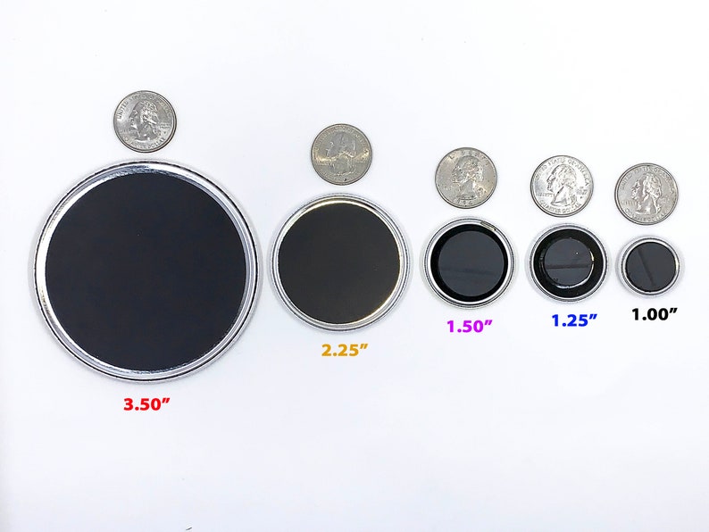 May include: A set of eight round, silver-rimmed magnets in various sizes, ranging from 1 inch to 3.5 inches in diameter. The magnets are arranged in order of size, with the largest magnet on the left and the smallest magnet on the right. The magnets are all black and have a smooth, glossy finish.