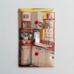 May include: A vintage-style light switch cover featuring a colourful image of a retro kitchen. The image depicts a sink, cabinets, and a countertop with bowls and eggs. The switch is labelled "OFF".
