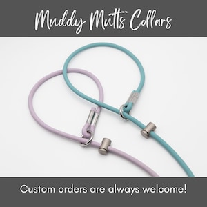 May include: Two dog collars, one light blue and one lavender, with silver hardware.  The collars are made of a soft, flexible material and are designed for comfort and durability.  Muddy Mutts Collars. Custom orders are always welcome!