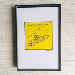 May include: A yellow card with a black line drawing of a cat riding a rocket with the text "BEAT HAPPENING" and the signature "todd!" at the bottom.