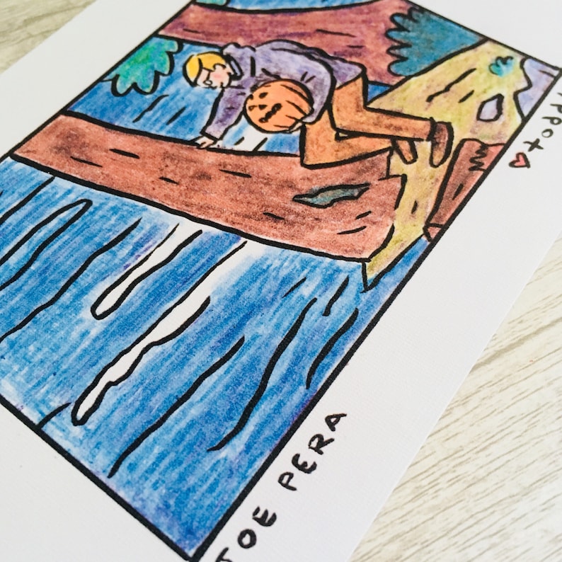 May include: A hand-drawn illustration of a person holding a pumpkin, sitting on a tree branch. The person is wearing a purple shirt and brown trousers. The background is a blue river with a brown tree trunk on the left side of the image. The text "TOE PERA" is written at the bottom of the image.
