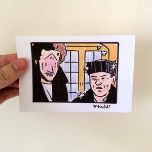 May include: A hand-drawn illustration of two men, one with a black eye and the other with a hat covered in stars. The man with the black eye is wearing a black jacket and the man with the hat is wearing a black jacket and a white shirt. The background is a yellow wall with a window. The text "todd!" is written in pink below the image.