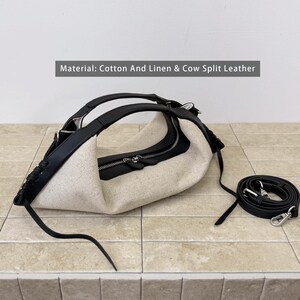 May include: A handbag made of beige cotton and linen with black cow split leather trim, featuring a top zipper closure, integrated handles, and a detachable black leather shoulder strap. Text on the image reads: Material: Cotton And Linen & Cow Split Leather.