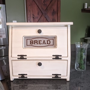 This D-LIGHTFUL DESIGNS ORIGINAL,  Bread box / Vegetable bin is made from Pine or Spruce wood.  Each one is handmade by my husband and each will be a bit different due to wood grain and natural knots and flaws.
ANTIQUED WHITE  SOLID BOTTOM DOOR