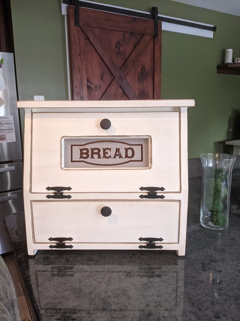 This D-LIGHTFUL DESIGNS ORIGINAL,  Bread box / Vegetable bin is made from Pine or Spruce wood.  Each one is handmade by my husband and each will be a bit different due to wood grain and natural knots and flaws.
ANTIQUED WHITE  SOLID BOTTOM DOOR