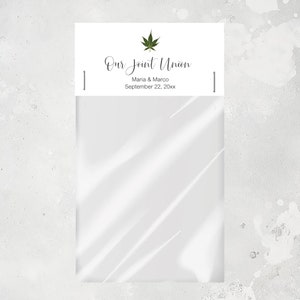 May include: White paper bag with a label that says "Our Joint Union" with a green marijuana leaf icon. The label also says "Maria & Marco" and "September 22, 20xx".