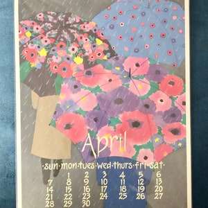May include: A vintage calendar featuring a watercolor illustration of three umbrellas with floral patterns. The umbrellas are depicted against a gray background with raindrops falling. The calendar is for April and shows the days of the week and dates.