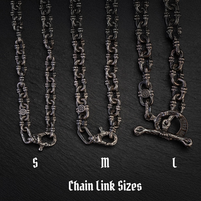 May include: Four silver-coloured chain necklaces with different link designs and clasps are displayed. The necklaces are labelled S, M, and L, with the text "Chain Link Sizes" below. The chains are shown against a dark background.