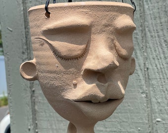 Eyes closed hanging face jug planter